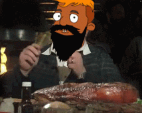 Bearded Man Sitting With Large Piece Of Meat GIF