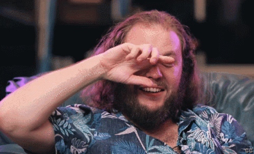 Bearded Man Smiling And Covering Eyes GIF