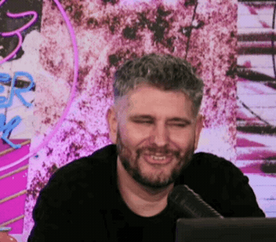 Bearded Man Smiling At Microphone In Front Of Computer GIF