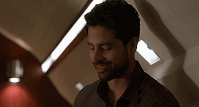 Bearded Man Smiling In Dark Room GIF