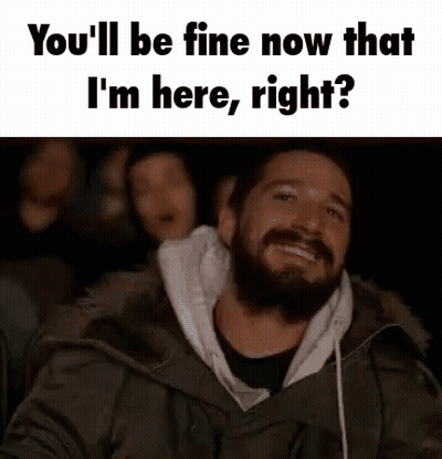 Bearded Man Smiling In Dark Room With Group GIF