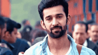 Bearded Man Smiling In Front Of Crowd GIF