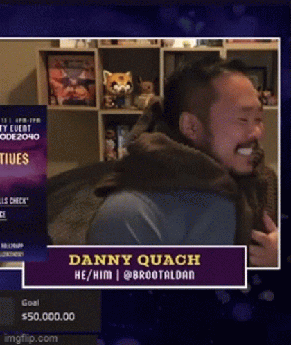 Bearded Man Smiling In Front Of Danny Quach Sign GIF