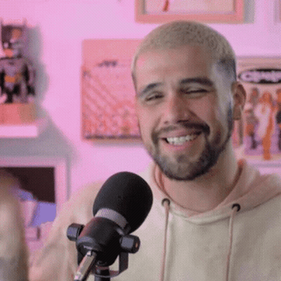 Bearded Man Smiling Into Microphone GIF