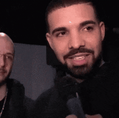 Bearded Man Smiling Next To Glasses Man GIF