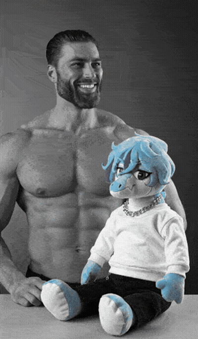 Bearded Man Smiling Next To Stuffed Animal With Blue Hair GIF