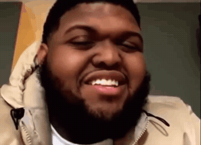 Bearded Man Smiling With Eyes Closed In Tan Jacket GIF