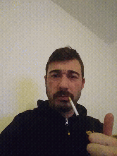 Bearded Man Smoking In Black Jacket With Yellow O GIF