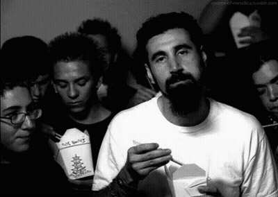 Bearded Man Smoking While Holding No Smoking Box GIF