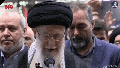 Bearded Man Speaking Into Microphone To Crowd GIF