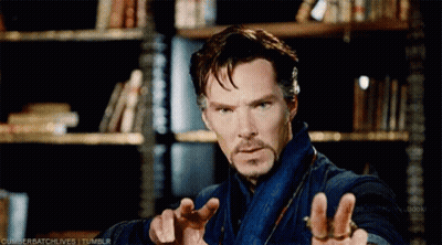 Bearded Man Standing At Bookshelf GIF