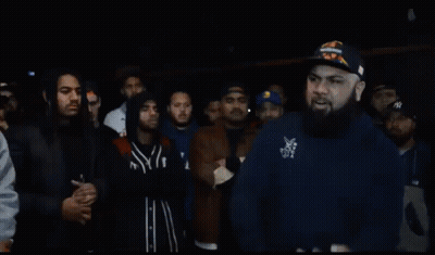 Bearded Man Standing Before Crowd GIF