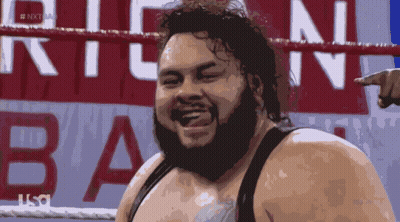 Bearded Man Standing Before Next Sign GIF