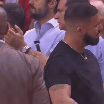 Bearded Man Standing In Crowd GIF