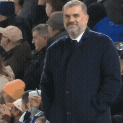 Bearded Man Standing In Crowd With Hands In Pockets GIF
