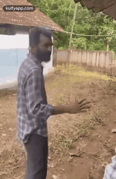 Bearded Man Standing In Dirt In Front Of House GIF