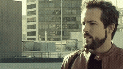 Bearded Man Standing In Front Of Building GIF