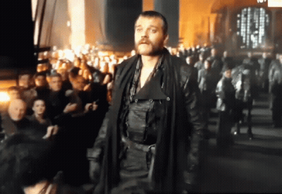 Bearded Man Standing In Front Of Crowd GIF