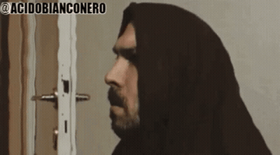 Bearded Man Standing In Front Of Door Wearing Hood GIF