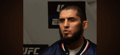 Bearded Man Standing In Front Of UFC Sign GIF