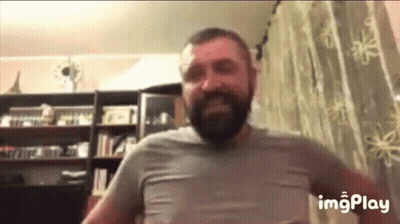 Bearded Man Standing In Front Of Window GIF
