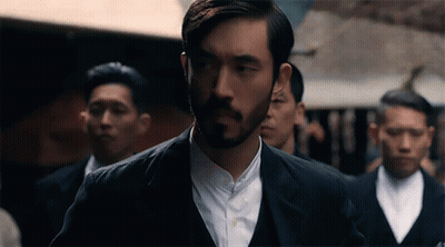 Bearded Man Standing In Line With Men In Suits GIF