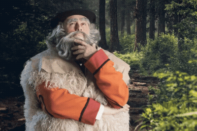 Bearded Man Standing In Woods Hand On Chin GIF