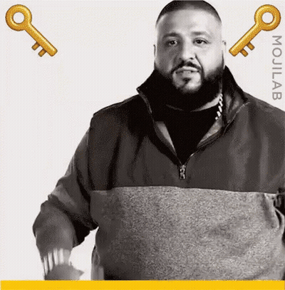 Bearded Man Standing Next To Two Keys GIF