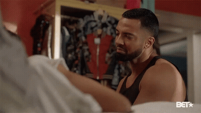 Bearded Man Standing Next To Woman In Bedroom GIF