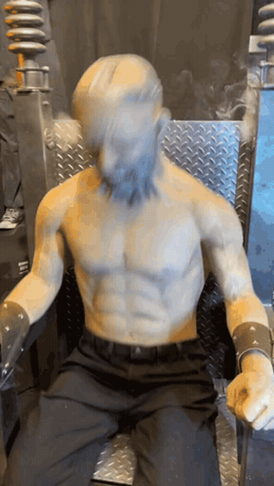 Bearded Man Statue Sitting On Chair GIF