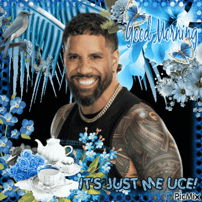 Bearded Man Surrounded By Blue Flowers Saying Good Morning GIF