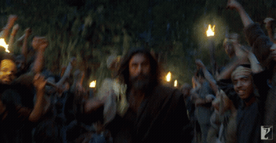 Bearded Man Surrounded By Crowd With Torches GIF