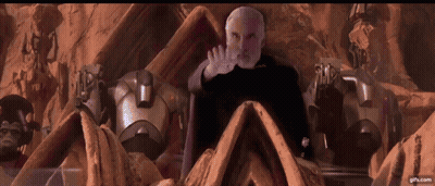 Bearded Man Surrounded By Robots GIF