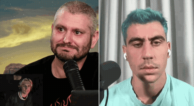 Bearded Man Talking Into Microphone Next To Blue-Haired Man GIF