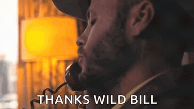Bearded Man Talking On Phone Saying Thanks Wild Bill GIF