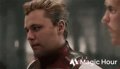 Bearded Man Talking To Man In Superhero Costume GIF