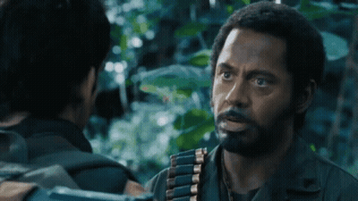 Bearded Man Talking To Man With Gun GIF