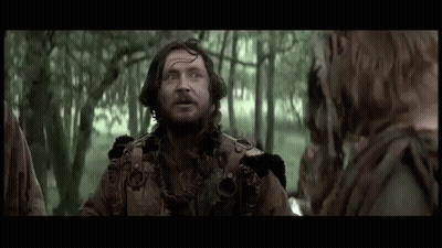 Bearded Man Talking To Woman In Woods GIF