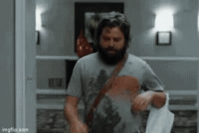 Bearded Man Walking With Towel GIF