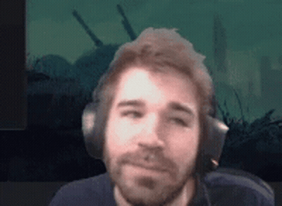 Bearded Man Wearing Headphones Against Green Background GIF