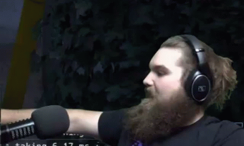 Bearded Man Wearing Headphones Pointing In Front Of Microphone GIF