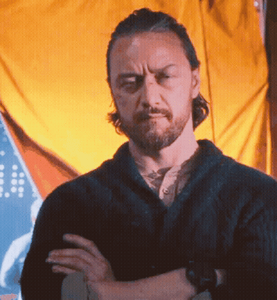 Bearded Man With Arms Crossed In Front Of Yellow Curtain GIF