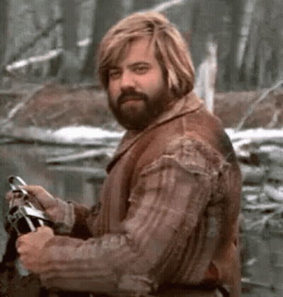 Bearded Man With Blonde Hair Holding Fishing Rod In Forest GIF