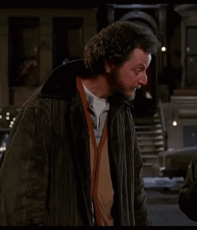 Bearded Man With Curly Hair On City Street GIF
