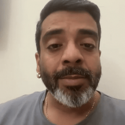 Bearded Man With Earrings In Gray Shirt GIF