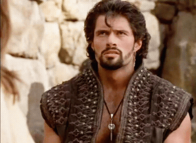 Bearded Man With Earrings Looking At Camera GIF
