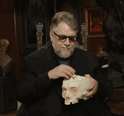 Bearded Man With Glasses Holding Skull GIF