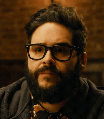 Bearded Man With Glasses Looking To Side GIF