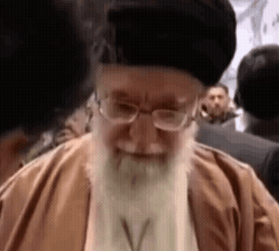 Bearded Man With Glasses Smiling Before Crowd GIF