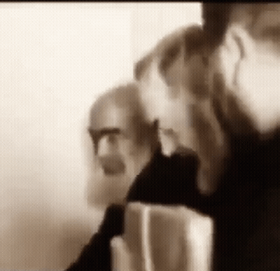Bearded Man With Glasses Talking On Cell Phone GIF
